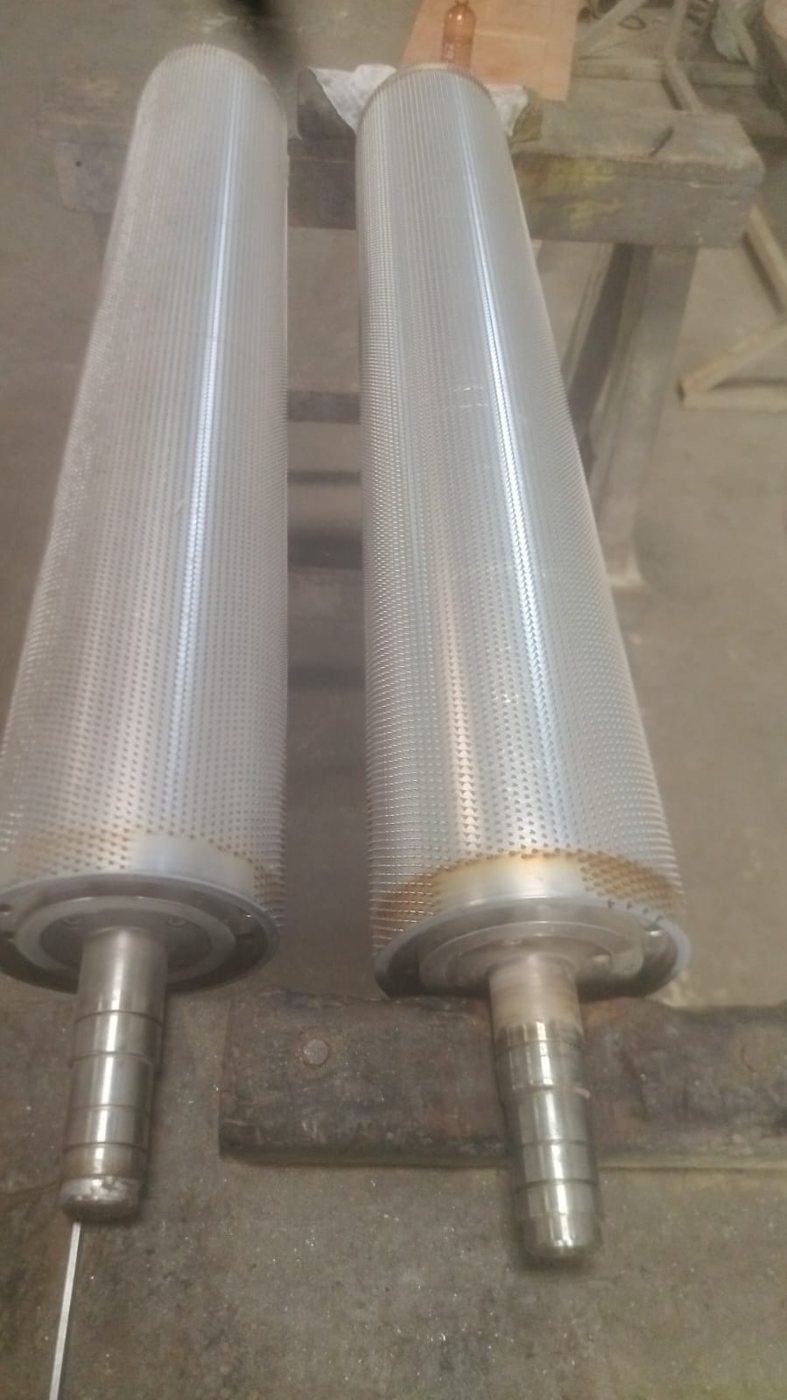 Two worn pinned licker-in rollers received for re-pinning, showing pin condition and shaft journals before inspection